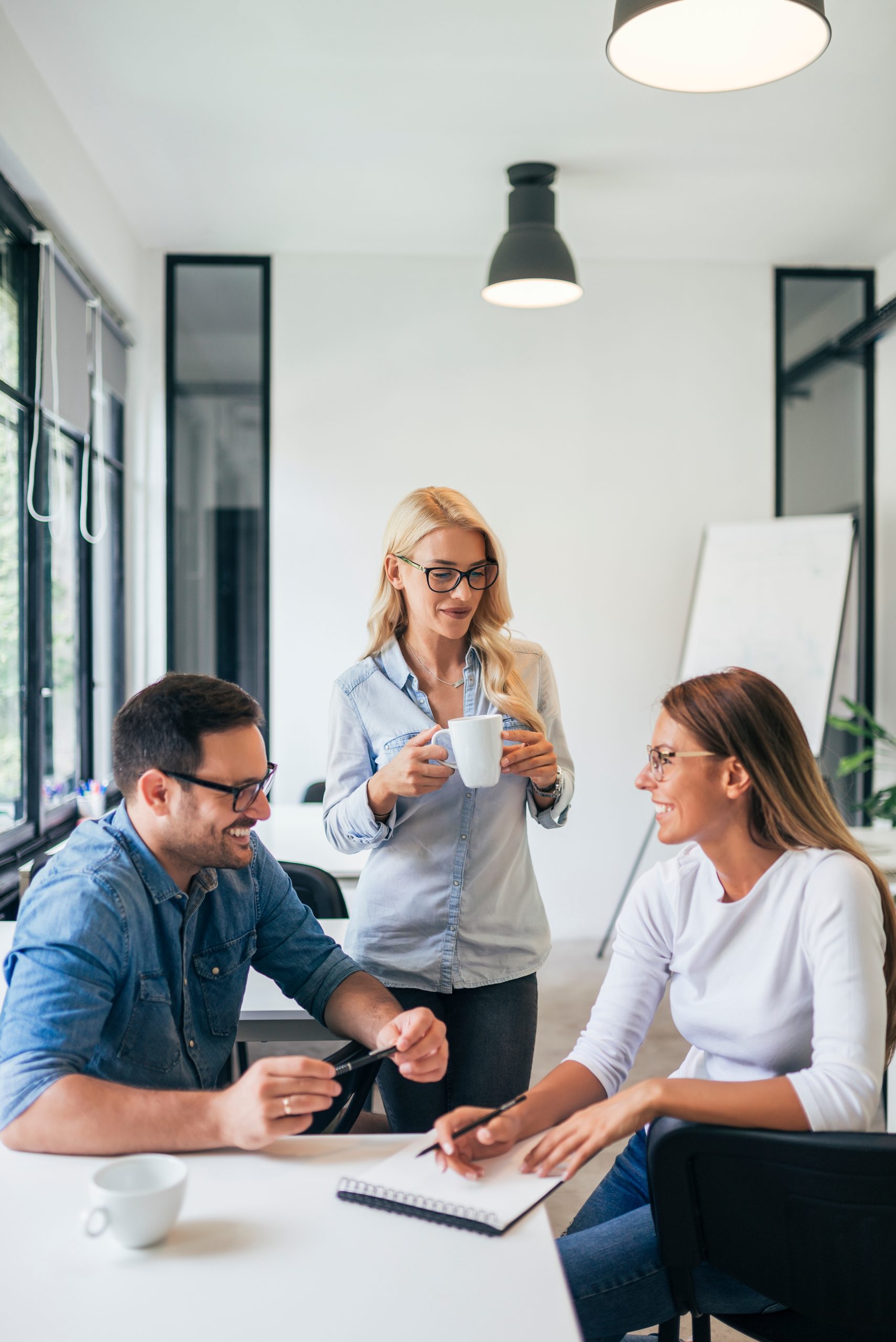 People in a meeting drinking coffee.